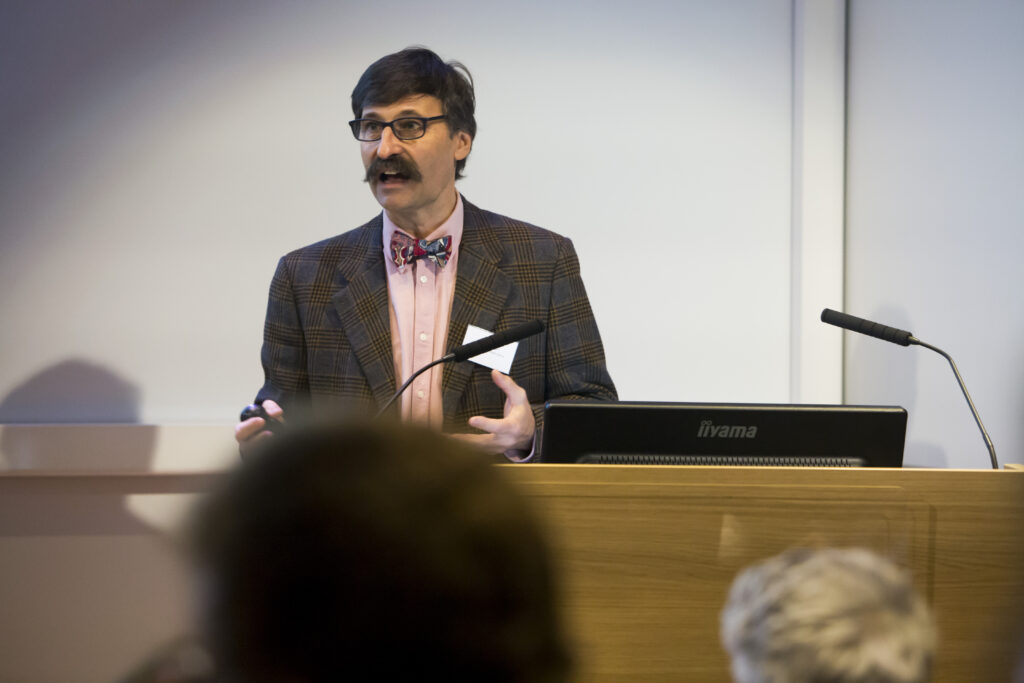 Alain Gregoire speaking at a podium at an event in 2018.
